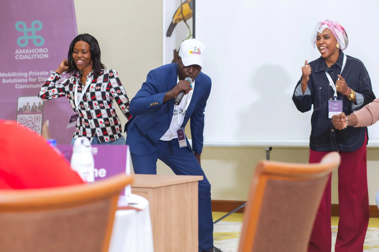 Fellows taking part in a lively session in front of an Amahoro Coalition banner