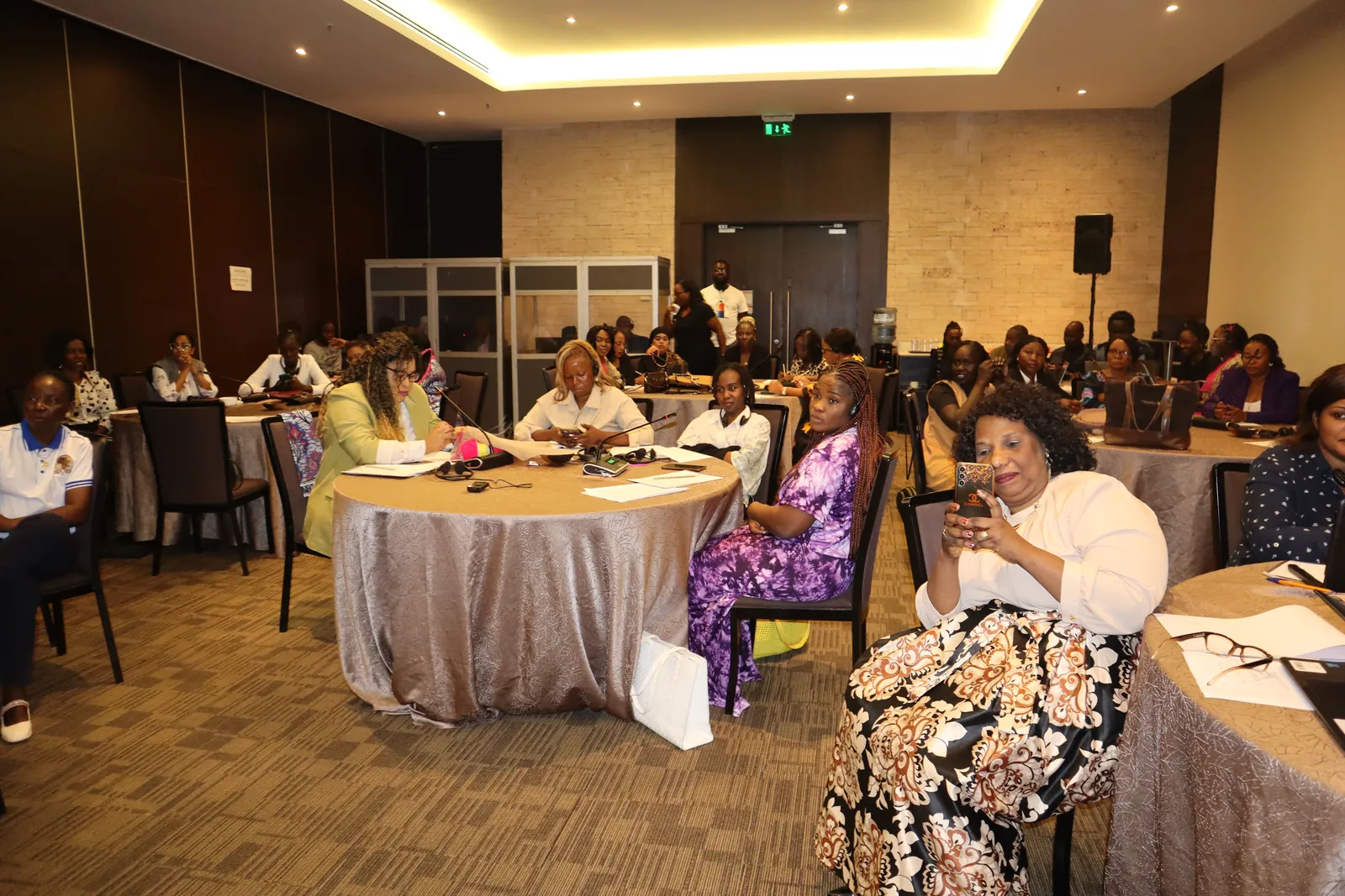 Participants seated at round tables in the workshop room in Nairobi
