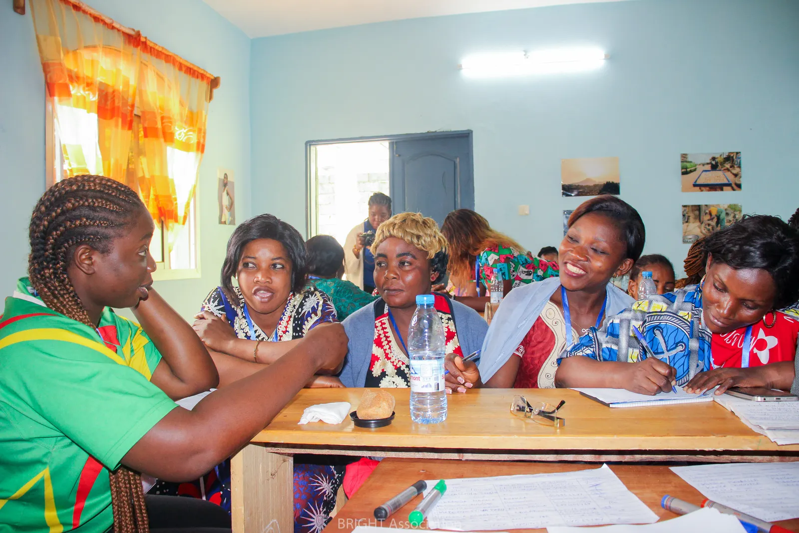 Women talking and taking notes around a table during a BRIGHT workshop